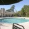 umbrella shaded seating next to pool