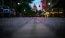 city street at night lined with parked cars