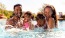 family with kids splash in a pool